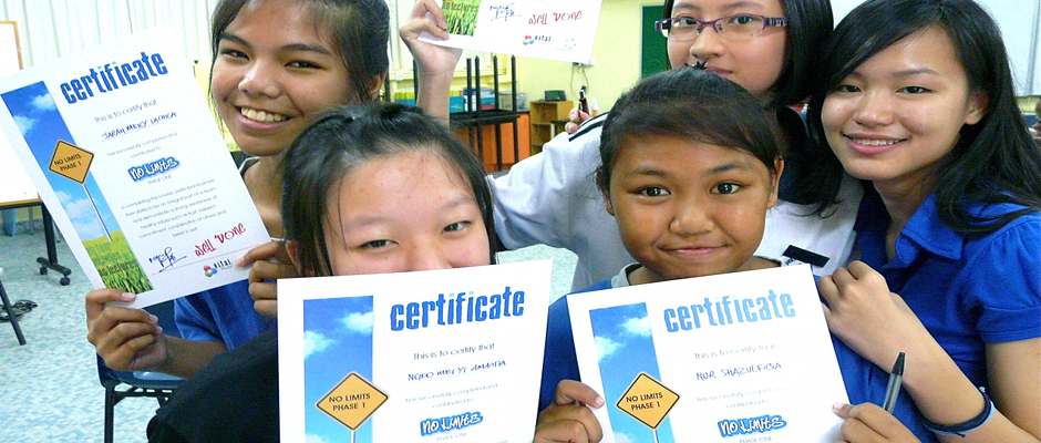 A group of girls proudly hold their certificates they earned after completing one of YouthWorks' courses.